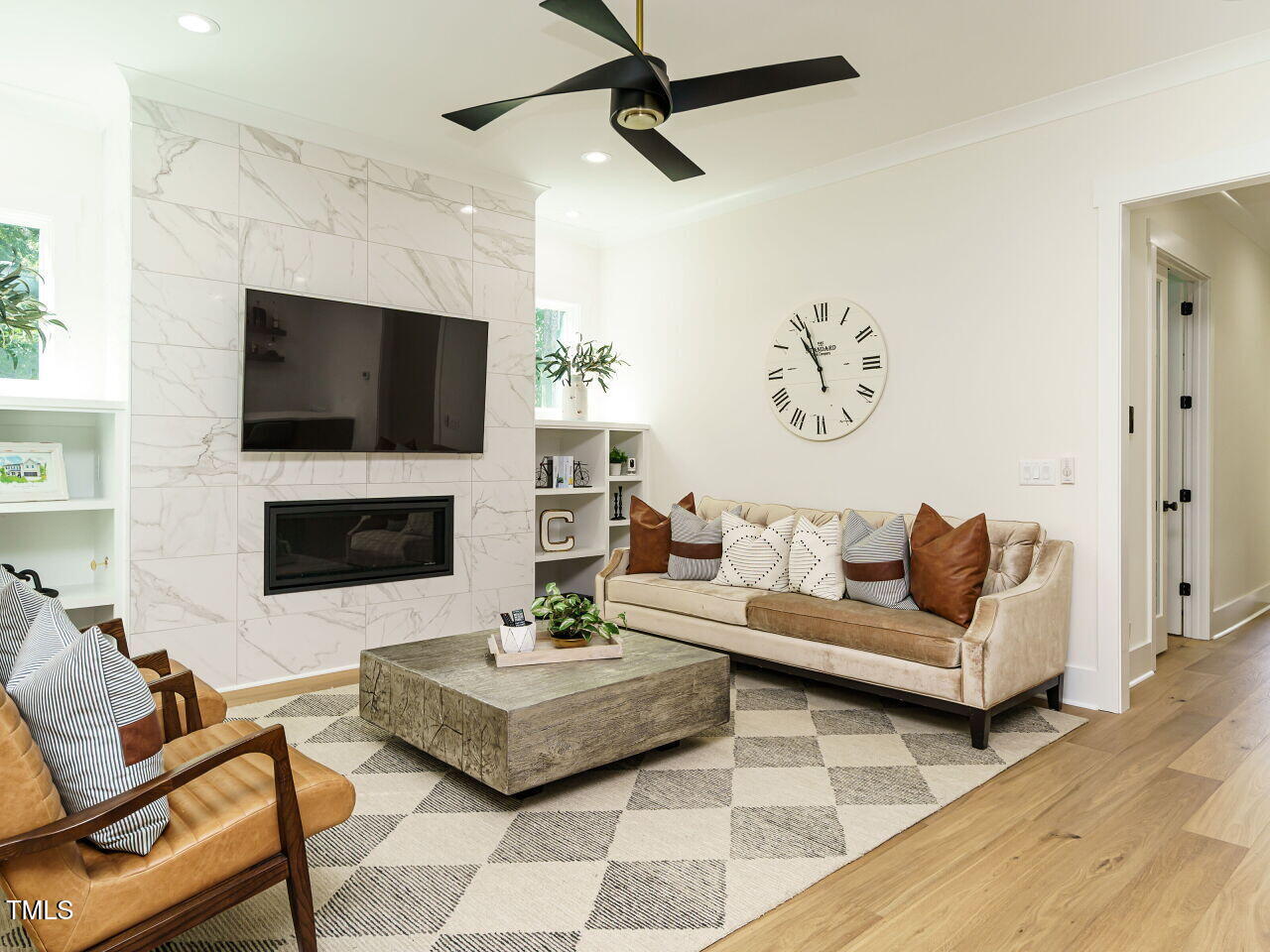 6428 Prescott Chase Drive Rolesville, NC 27571 - Photo 13 of 45 a living room with furniture a flat screen tv and a fireplace