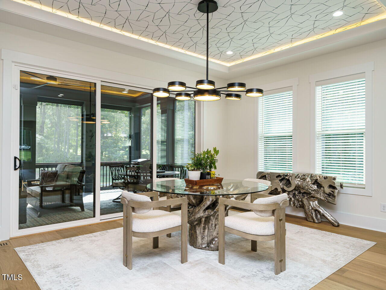 6428 Prescott Chase Drive Rolesville, NC 27571 - Photo 17 of 45 a living room with patio furniture and a chandelier