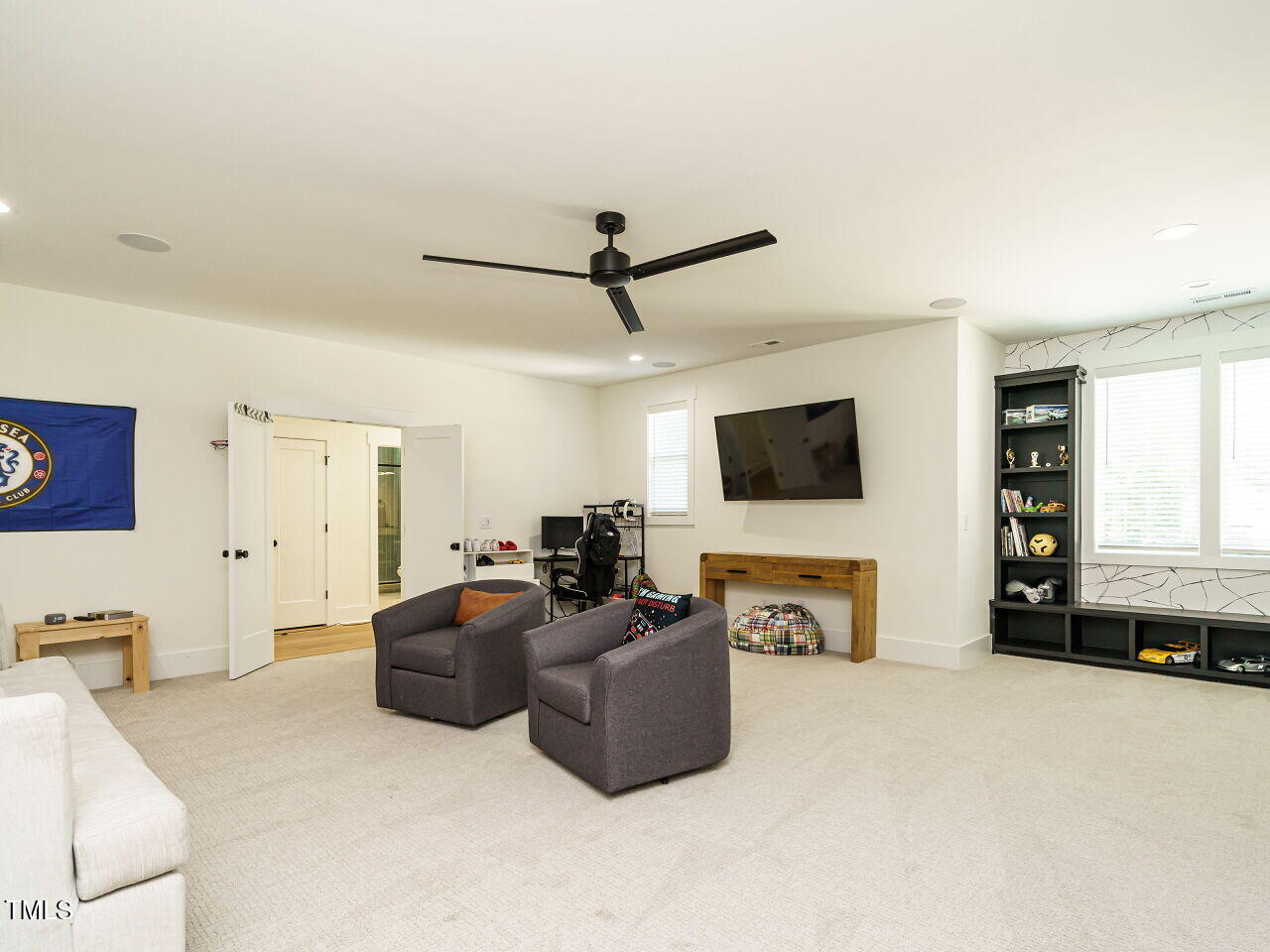 6428 Prescott Chase Drive Rolesville, NC 27571 - Photo 33 of 45 a living room with furniture a flat screen tv and a fireplace
