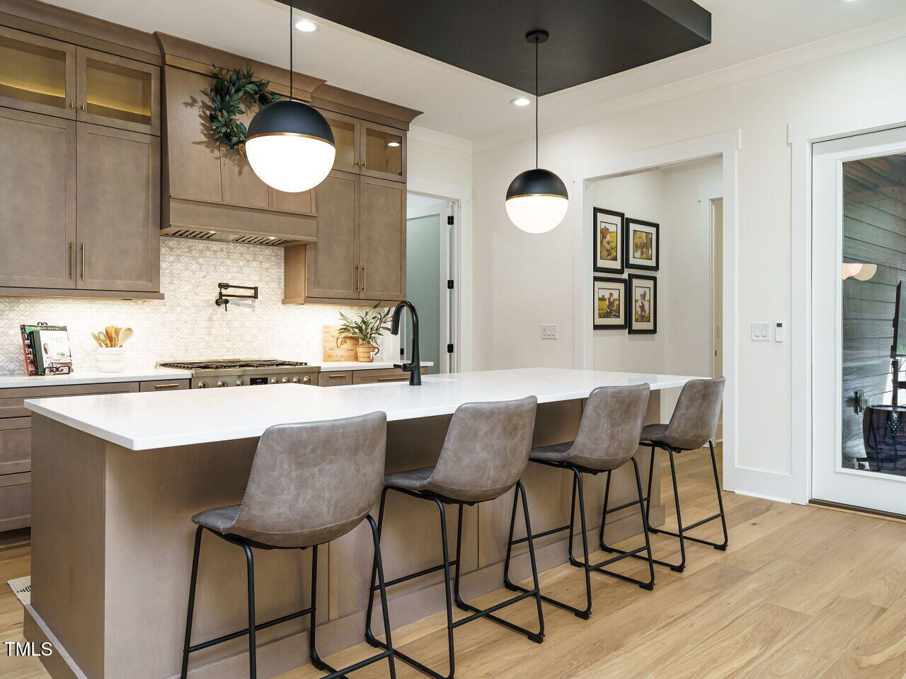 6428 Prescott Chase Drive Rolesville, NC 27571 - Photo 6 of 45 a kitchen with a dining table a sink and cabinets