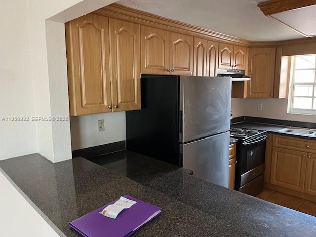 4250 West 11th Lane, Unit 43 Hialeah, FL 33012 - Photo 14 of 31 a kitchen with granite countertop stainless steel appliances a refrigerator stove and microwave