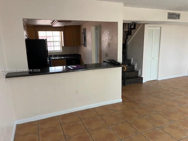 4250 West 11th Lane, Unit 43 Hialeah, FL 33012 - Photo 15 of 31 a living room with stainless steel appliances kitchen island granite countertop a sink a stove and a refrigerator
