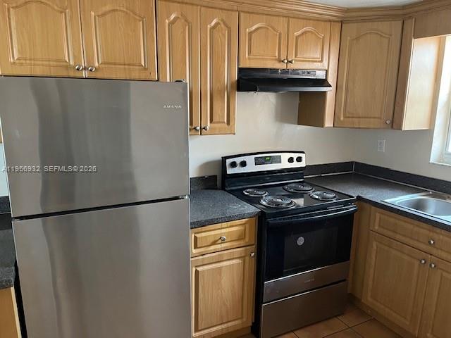 4250 West 11th Lane, Unit 43 Hialeah, FL 33012 - Photo 16 of 31 a stove top oven sitting inside of a kitchen