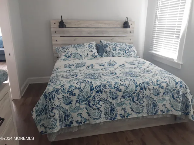 a bed sitting in a bedroom next to a window