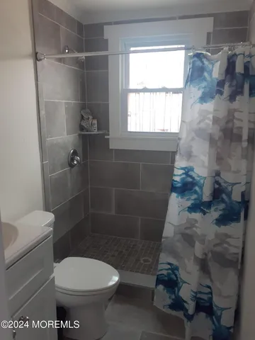 a bathroom with a toilet and a shower