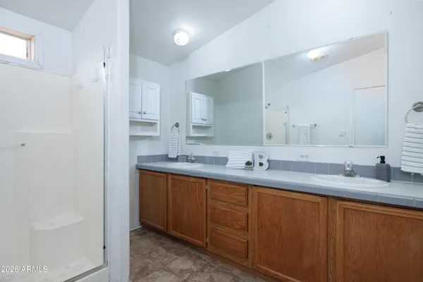 an empty room with a window and a ceiling fan