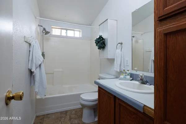 a utility room with a sink a cabinetry and window