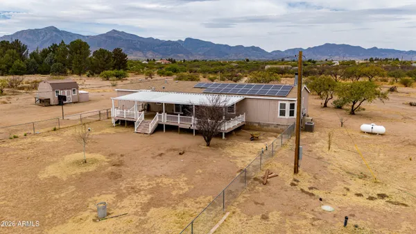 an empty room with furniture and a ceiling fan