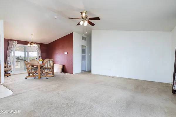 a view of an empty room with window and cabinet