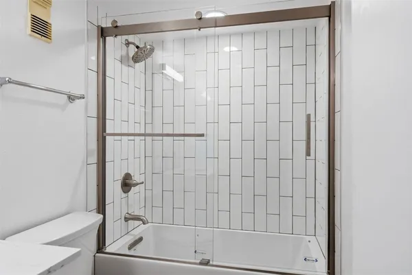 a bathroom with a shower and a bathtub