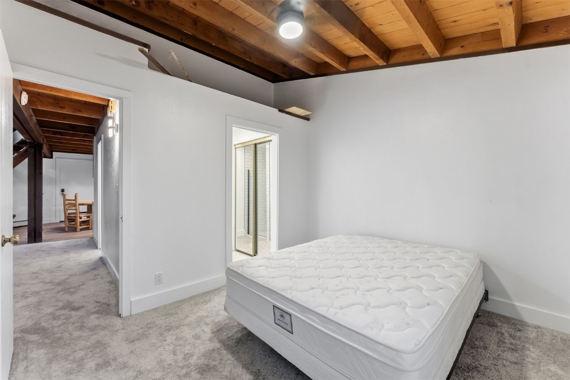 4200 Lodgepole Circle, Unit 306 Silverthorne, CO 80498 - Photo 13 of 26 a large bed sitting in a room next to a window