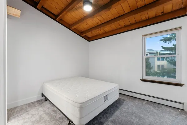 a bed sitting in a room next to a window