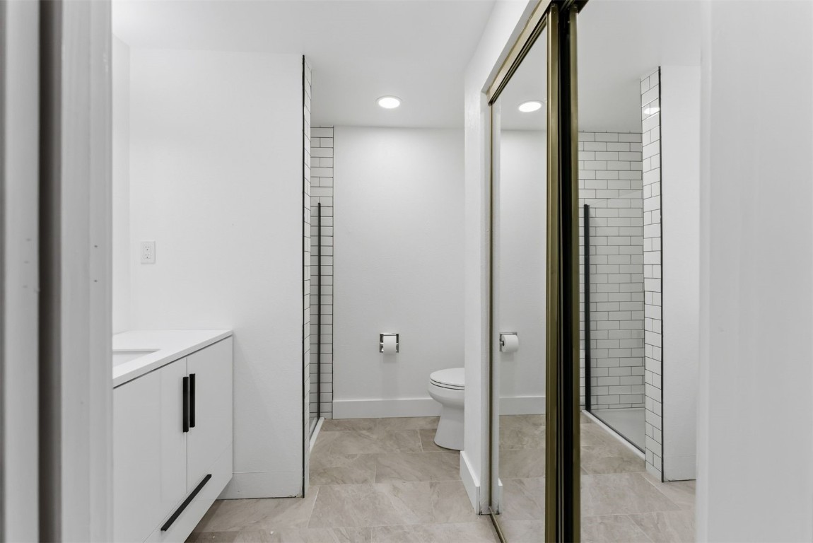 4200 Lodgepole Circle, Unit 306 Silverthorne, CO 80498 - Photo 16 of 26 a bathroom with a granite countertop sink a toilet and shower