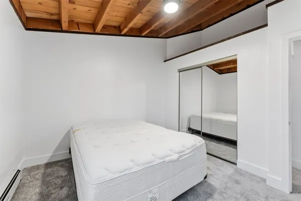 a room with a bed and a dresser