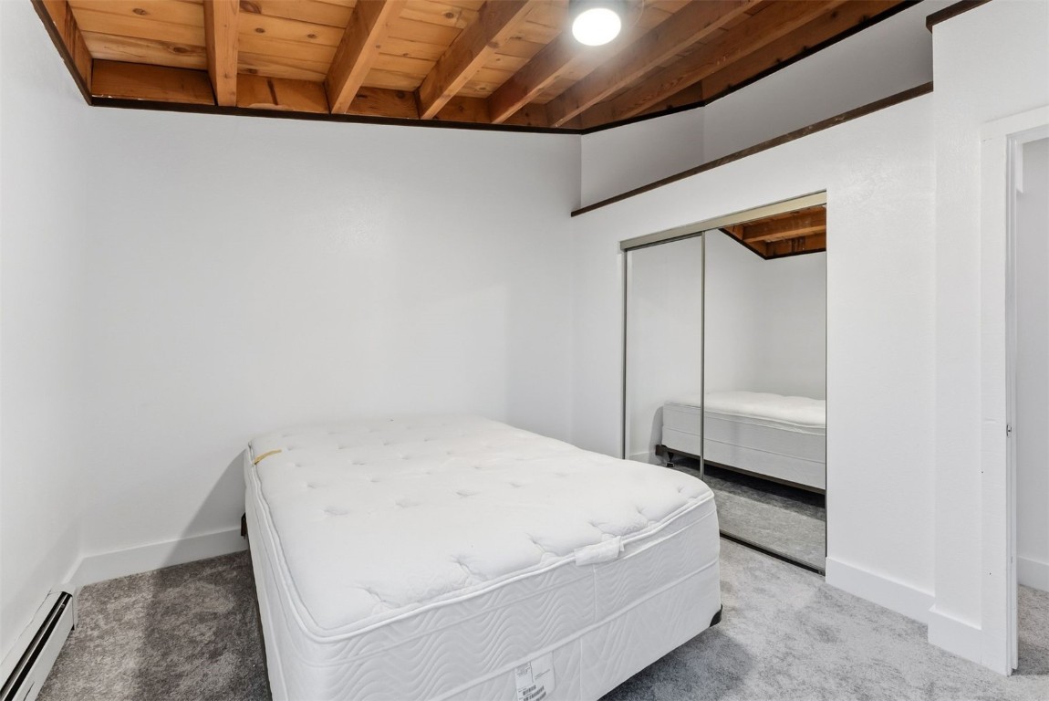 4200 Lodgepole Circle, Unit 306 Silverthorne, CO 80498 - Photo 19 of 26 a room with a bed and a dresser