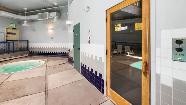a view of a hallway with a dining table and a mirror