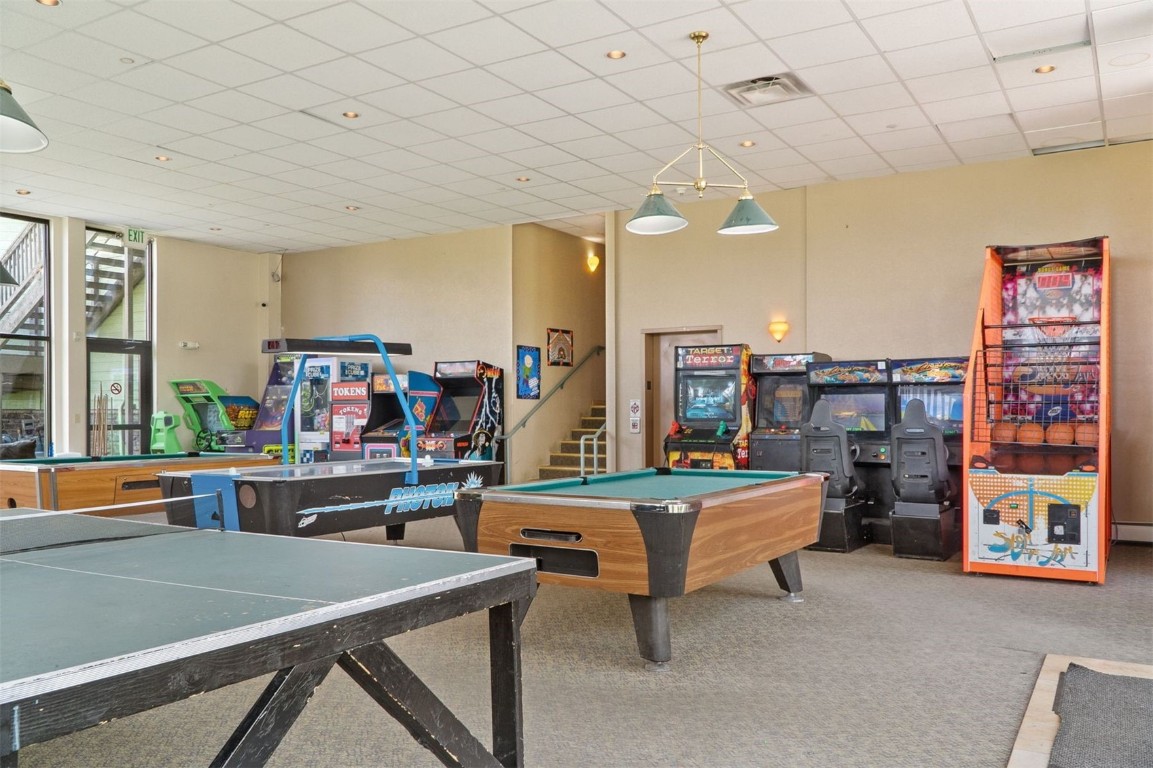 4200 Lodgepole Circle, Unit 306 Silverthorne, CO 80498 - Photo 22 of 26 a room with furniture and a table