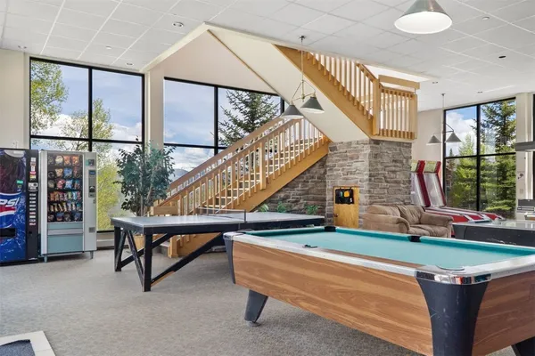 a living room with chairs and a table