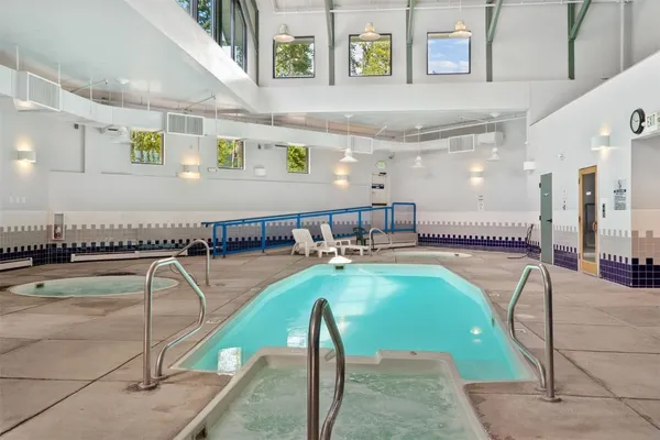 a view of a swimming pool and lounge chair