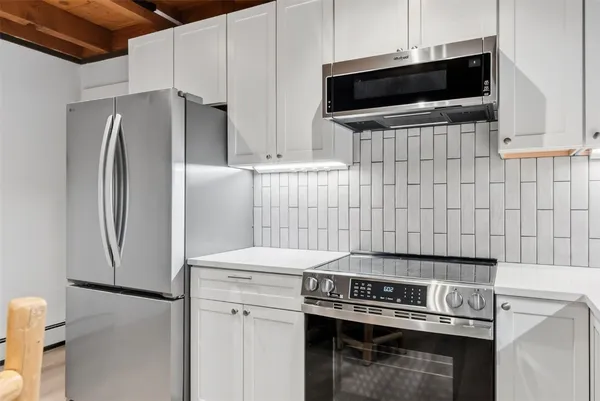 a kitchen with a stove and a microwave
