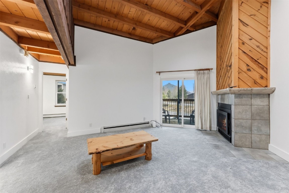 4200 Lodgepole Circle, Unit 306 Silverthorne, CO 80498 - Photo 9 of 26 a spacious bedroom with a bed and a fireplace
