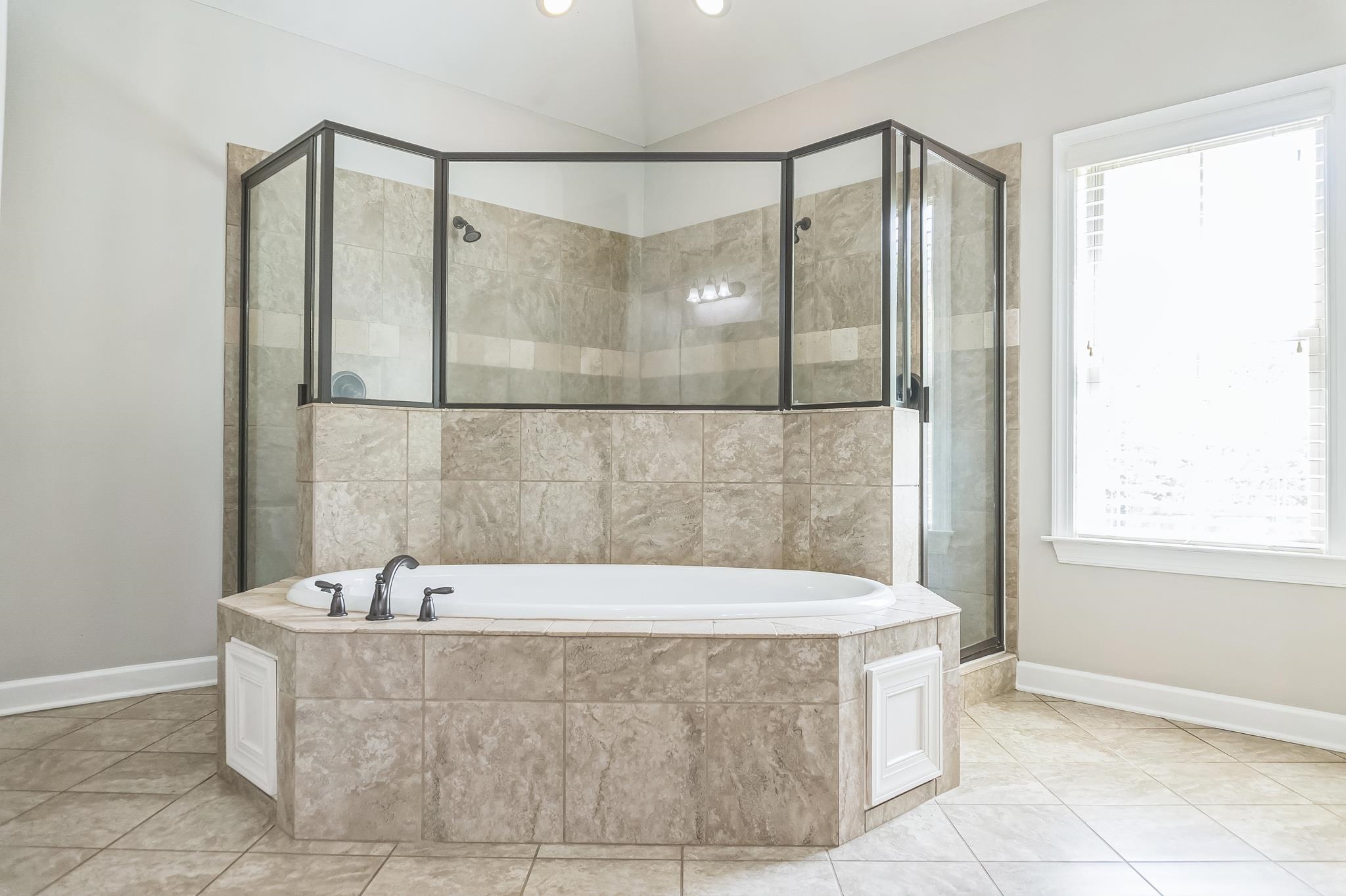 4948 Grace View Lane Bartlett, TN 38135 - Photo 13 of 21 a bathroom with a bathtub and a shower