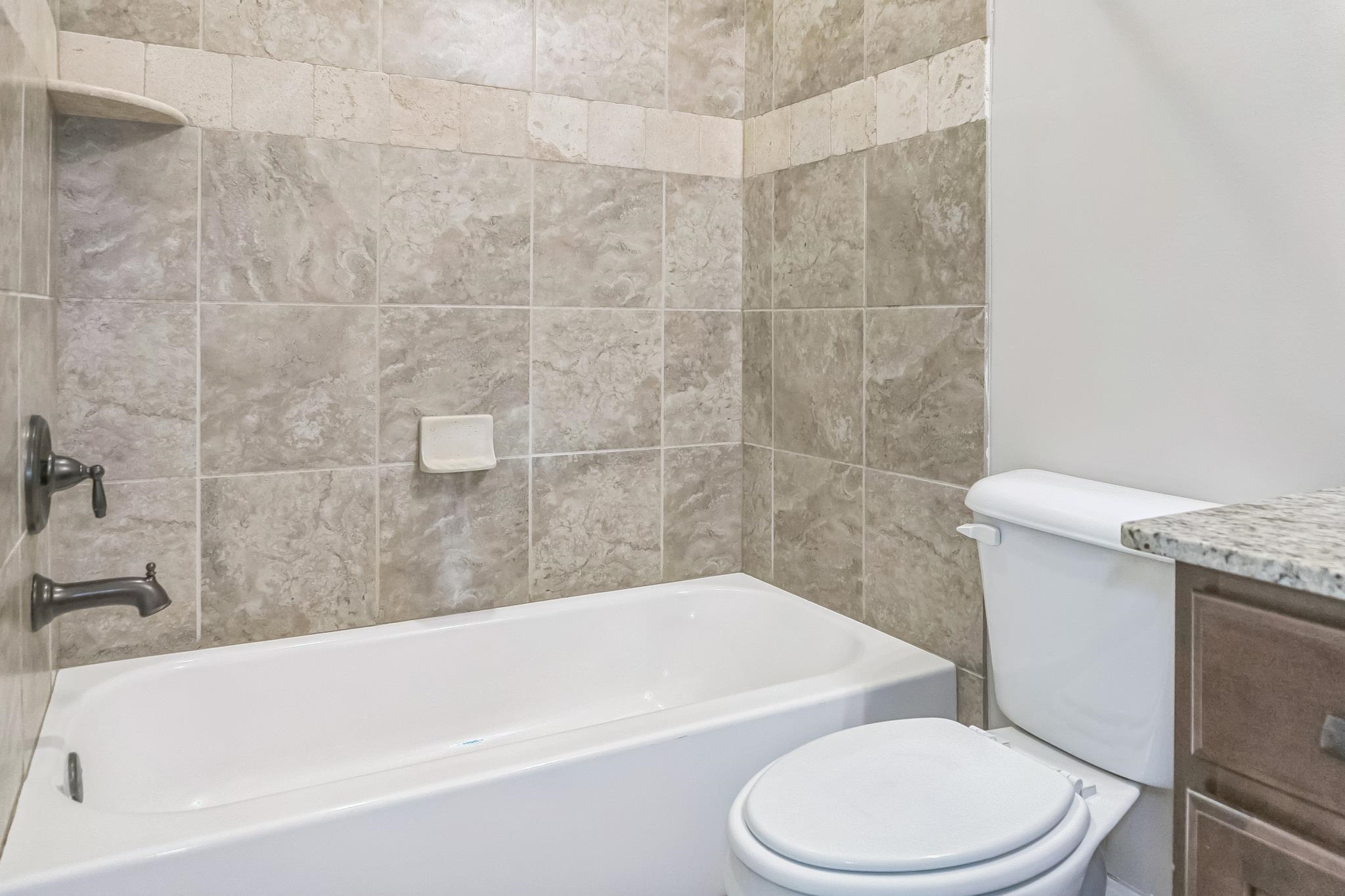 4948 Grace View Lane Bartlett, TN 38135 - Photo 19 of 21 a white bath tub sitting next to a white toilet