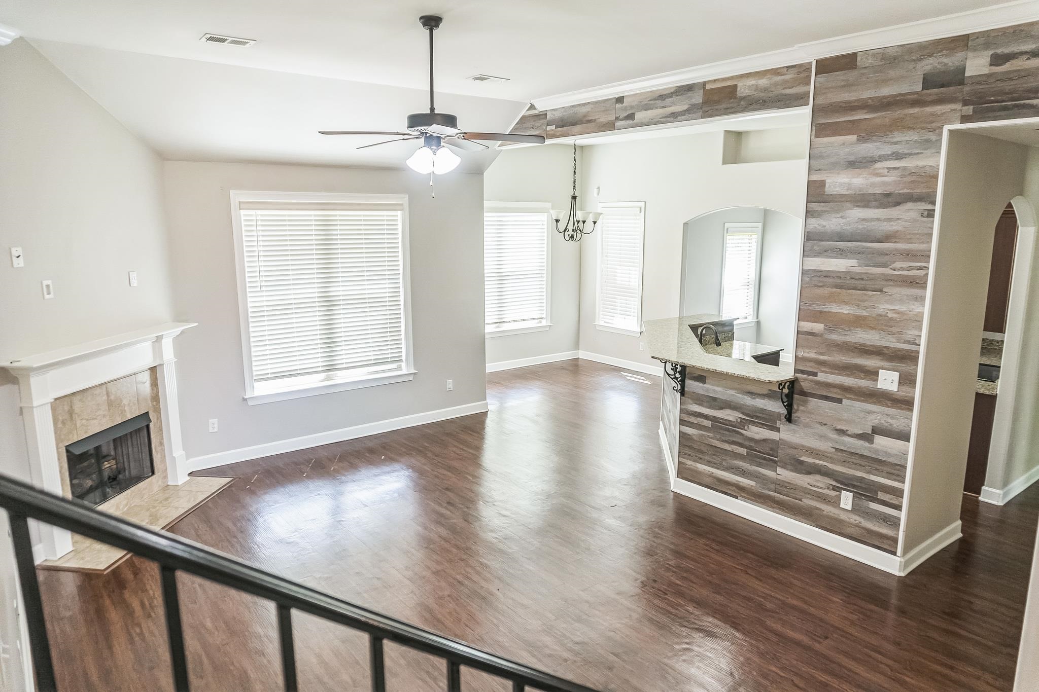 4948 Grace View Lane Bartlett, TN 38135 - Photo 3 of 21 wooden floor in an empty room with a window