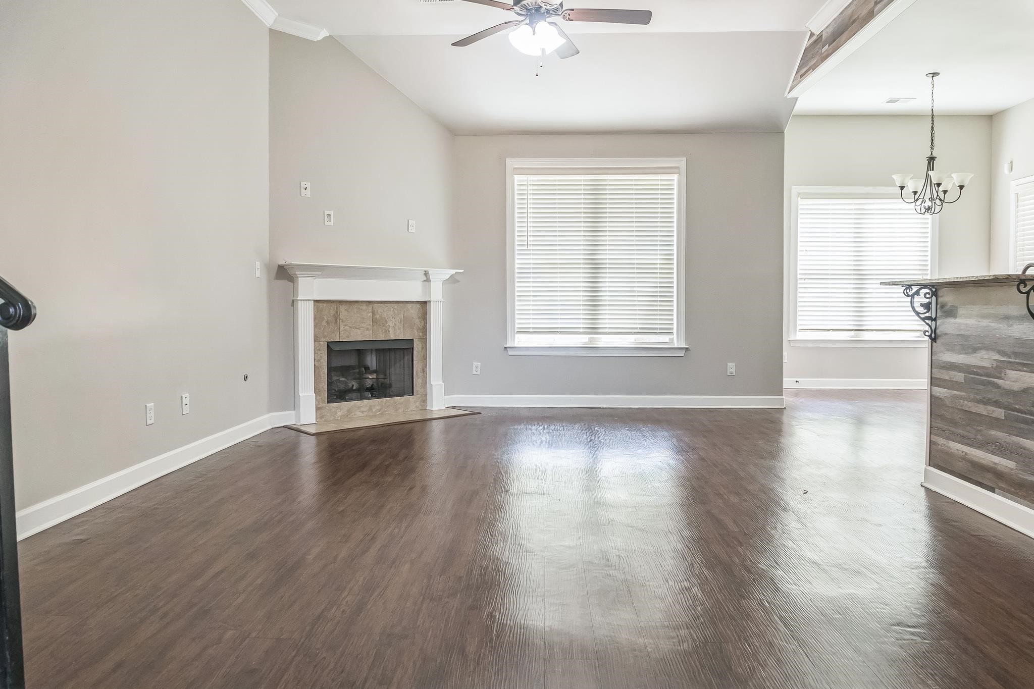 4948 Grace View Lane Bartlett, TN 38135 - Photo 4 of 21 an empty room with wooden floor fireplace and windows