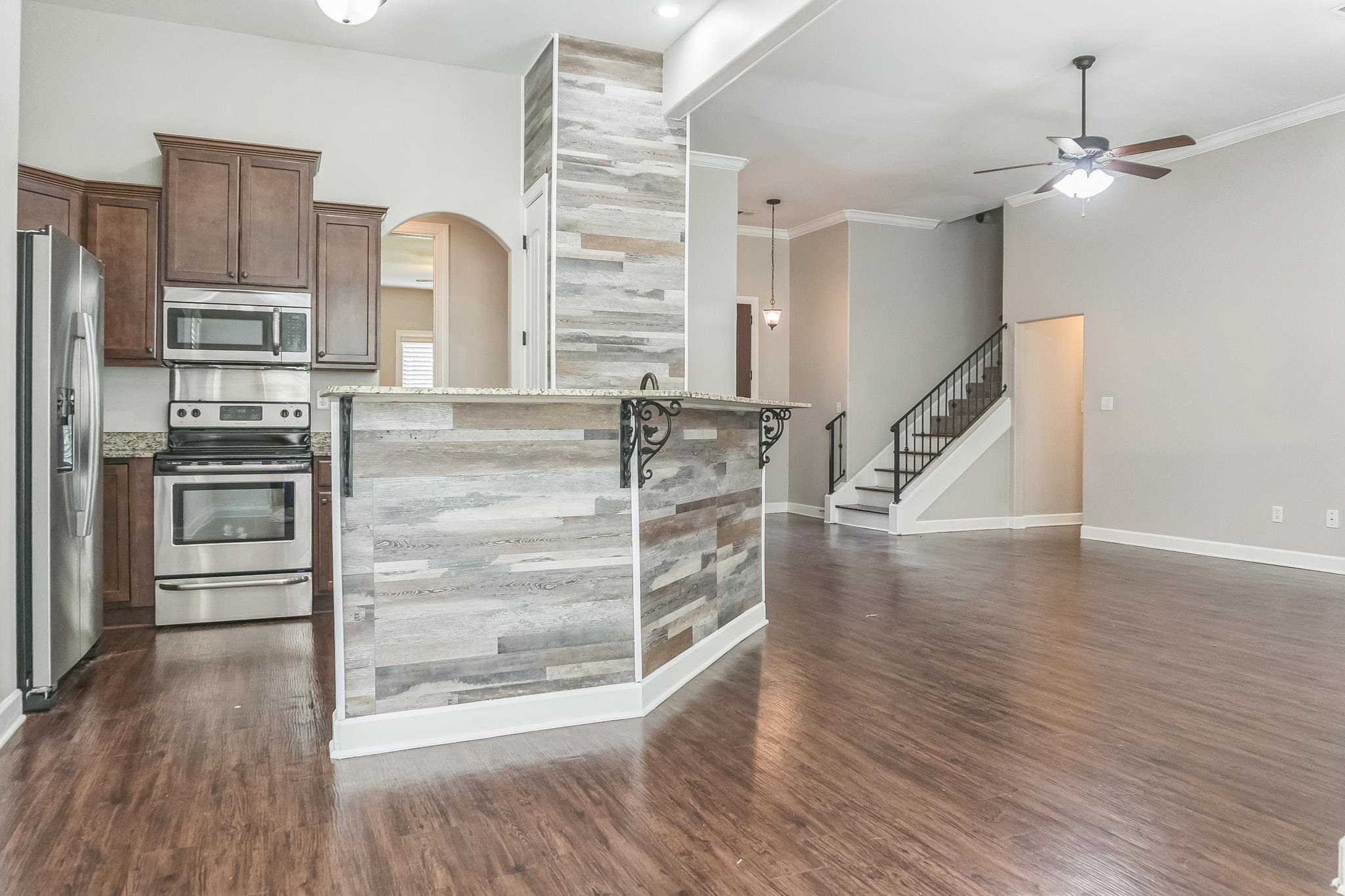 4948 Grace View Lane Bartlett, TN 38135 - Photo 5 of 21 a view of a kitchen with wooden floor and electronic appliances