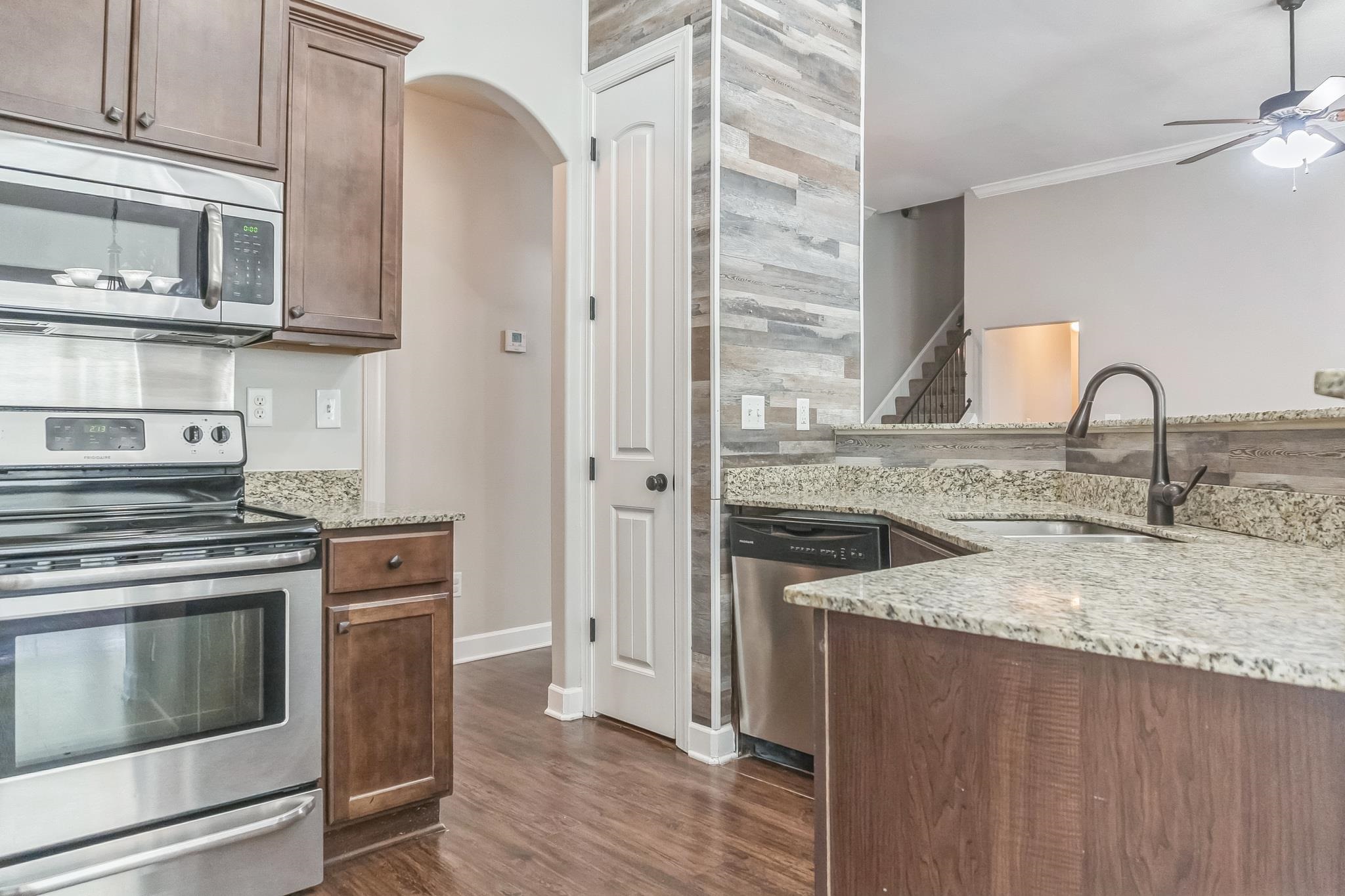 4948 Grace View Lane Bartlett, TN 38135 - Photo 6 of 21 a kitchen with stainless steel appliances granite countertop a stove and a sink