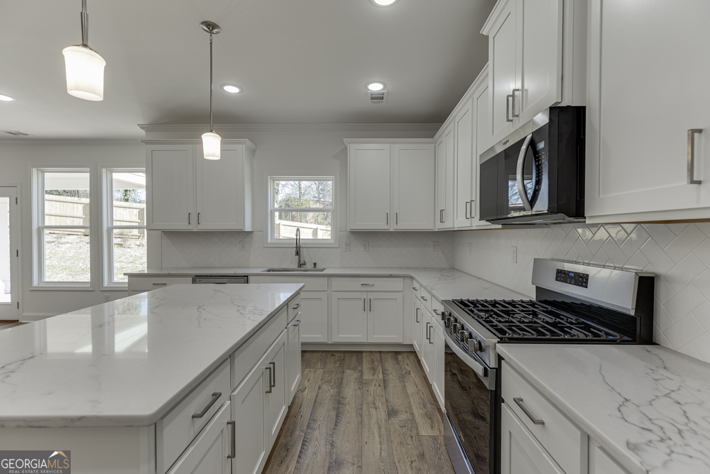 929 Lakeview Drive Commerce, GA 30529 - Photo 13 of 44 a kitchen with stainless steel appliances granite countertop a stove a sink and a microwave