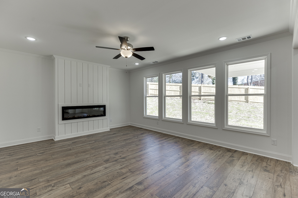 929 Lakeview Drive Commerce, GA 30529 - Photo 18 of 44 a view of an empty room with a kitchen and wooden floor