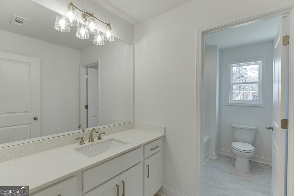 929 Lakeview Drive Commerce, GA 30529 - Photo 27 of 44 a bathroom with a toilet sink and mirror