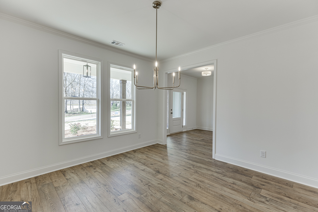 929 Lakeview Drive Commerce, GA 30529 - Photo 7 of 44 a view of an empty room with wooden floor and a window