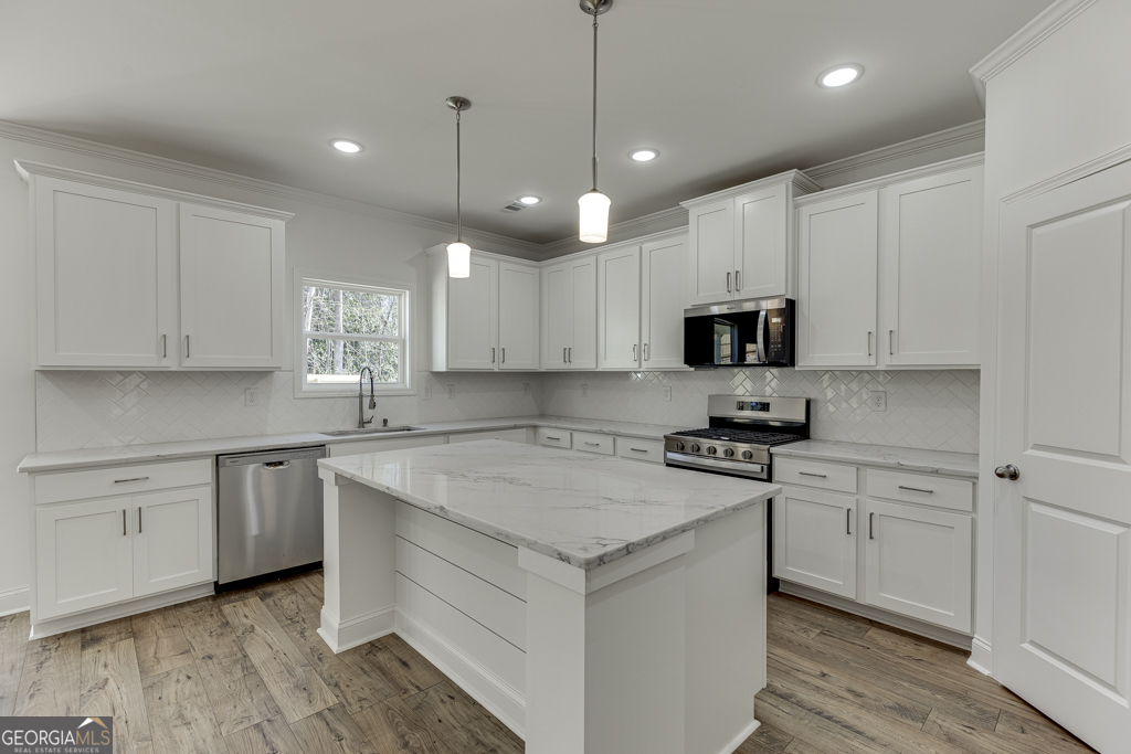 929 Lakeview Drive Commerce, GA 30529 - Photo 8 of 44 a kitchen with cabinets appliances a sink and a counter top space