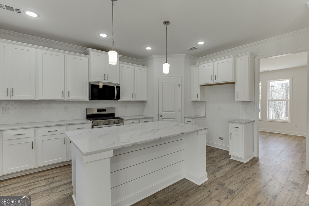 929 Lakeview Drive Commerce, GA 30529 - Photo 10 of 44 a kitchen with a sink a center island stainless steel appliances and cabinets