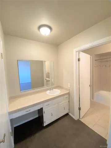 a bathroom with a double vanity sink a mirror and a bathtub