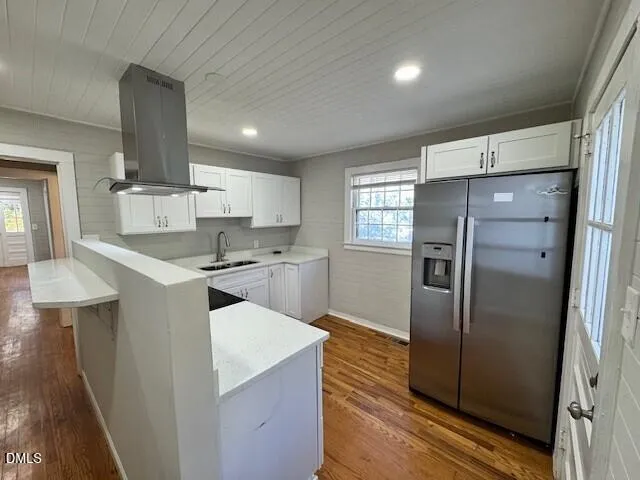 a kitchen with a refrigerator sink and cabinets
