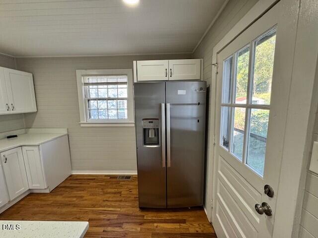 1012 Berkeley Street Durham, NC 27705 - Photo 7 of 12 a view of a refrigerator in kitchen and an empty room in wooden floor