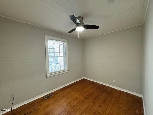 an empty room with wooden floor and closet