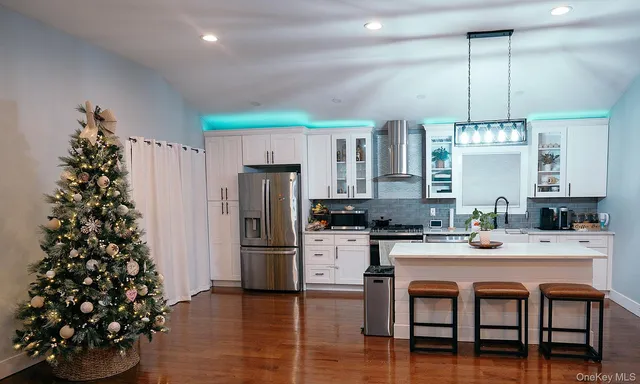 a kitchen with granite countertop a refrigerator and a stove