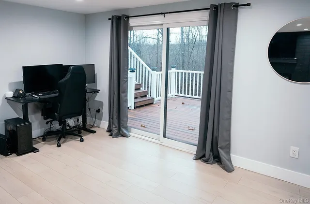 a view of a workspace with furniture and a gate