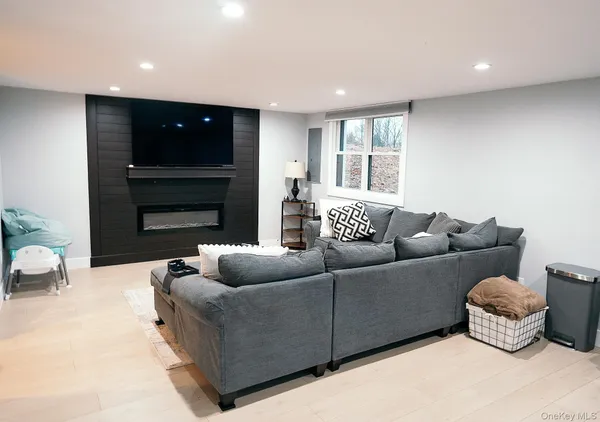 a living room with furniture window and a fireplace