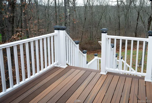 a view of balcony with wooden floor and fence