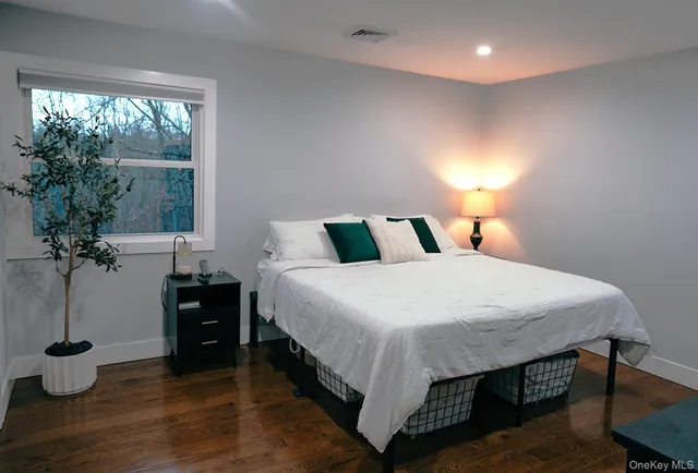 a bedroom with a bed and window