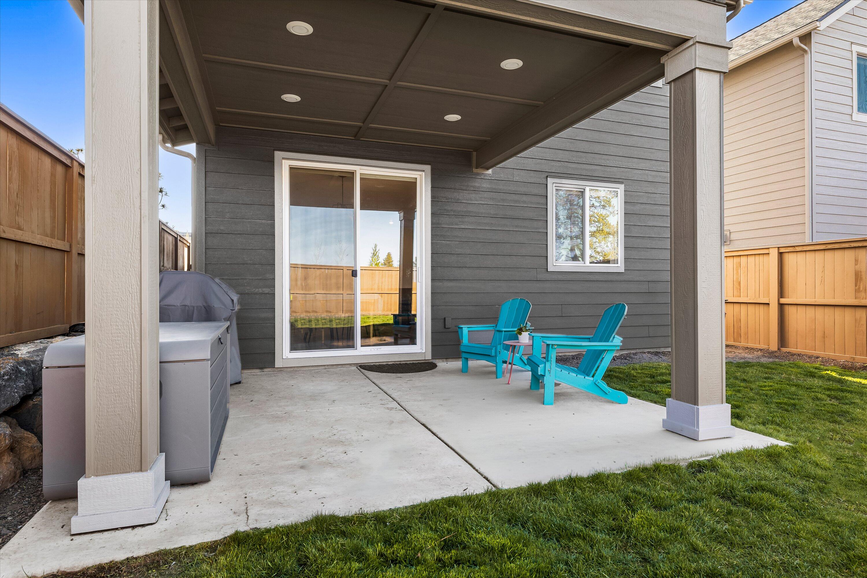 60903 Southeast Epic Place Bend, OR 97702 - Photo 35 of 48 a chairs and table in a backyard of the house
