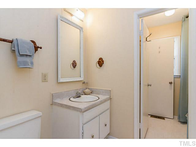 1317 Clermont Road Durham, NC 27713 - Photo 14 of 25 a bathroom with a sink mirror and vanity