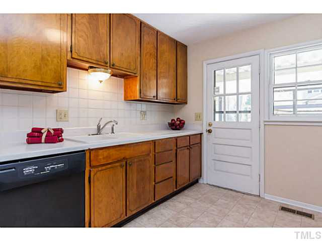 1317 Clermont Road Durham, NC 27713 - Photo 5 of 25 a kitchen with granite countertop cabinets stainless steel appliances and sink