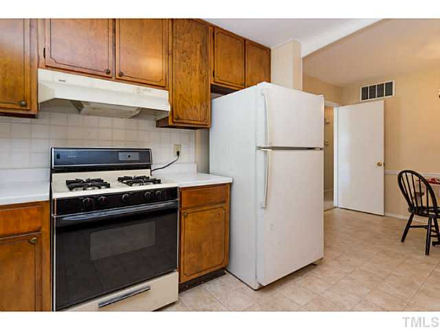 1317 Clermont Road Durham, NC 27713 - Photo 9 of 25 a kitchen with a refrigerator sink and cabinets